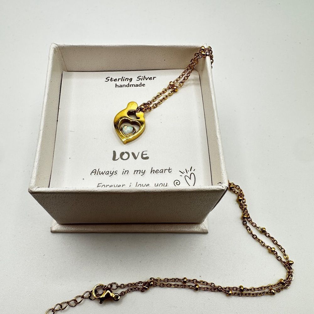 NIB gold tone "mother and child" holding opal, 18" necklace!